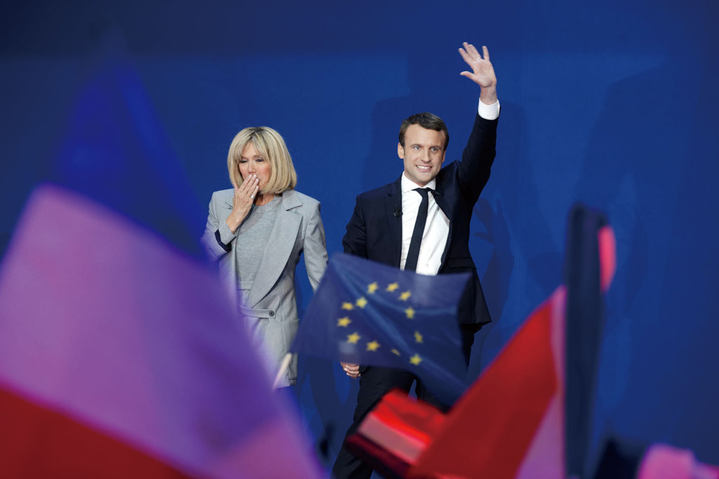 PARIS, FRANCE - APRIL 23: Founder and Leader of the political movement 'En Marche !' Emmanuel Macron, flanked by his wife Brigitte Trogneux, speaks after projected results suggest that he has won the lead percentage of votes in the first round of the French Presidential Elections at Parc des Expositions Porte de Versailles on April 23, 2017 in Paris, France. Macron and National Front Party Leader Marine Le Pen, will compete in the next round of the French Presidential Elections on May 7 to decide the next President of France. (Photo by Sylvain Lefevre/Getty Images)